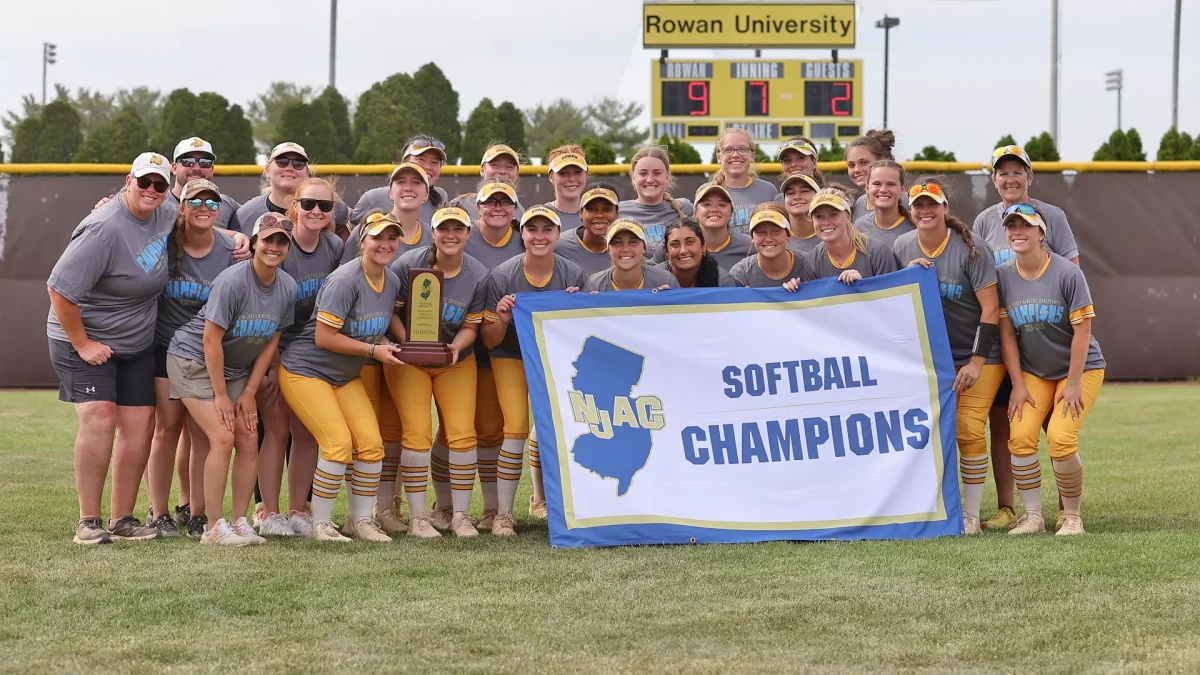 The Rowan softball team poses with their NJAC Champions banner. The program has won back-to-back conference titles for the first time since the 2001-02 seasons. Glassboro, NJ. Sunday, May 11, 2025. - Photo via Rowan Athletics