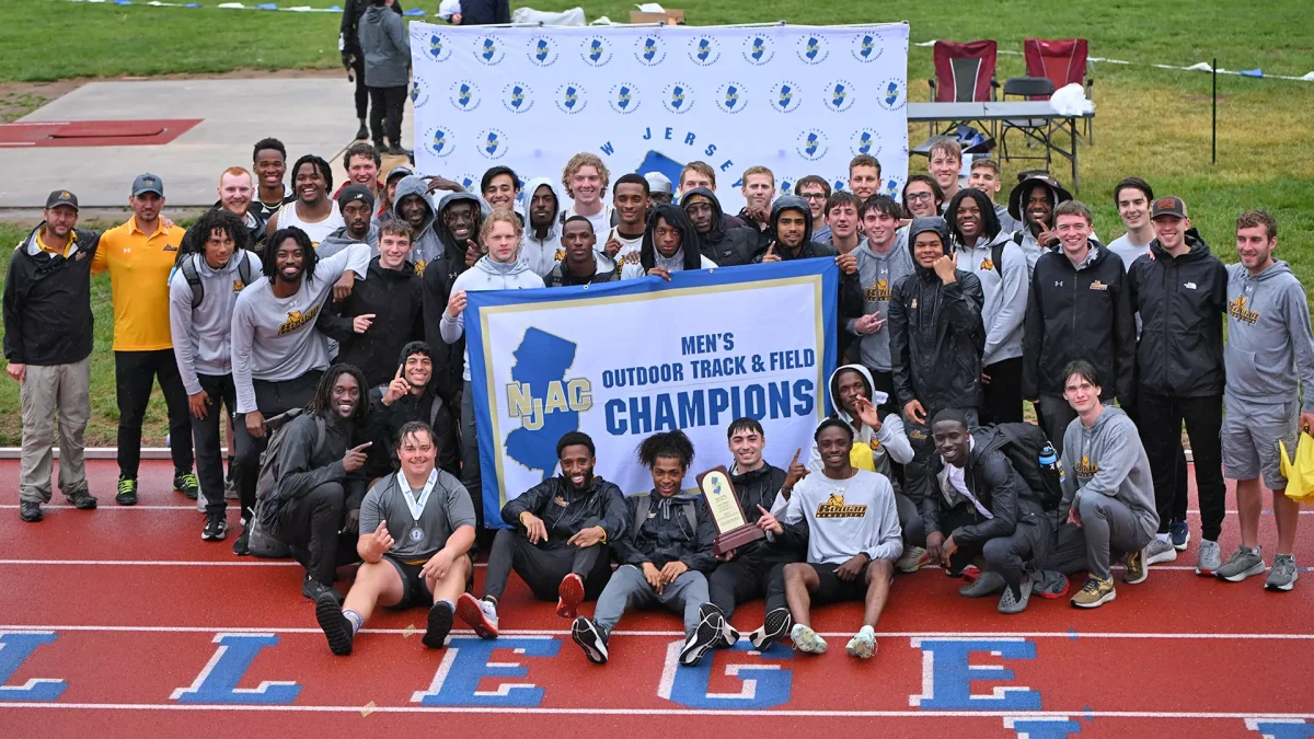 The Rowan men's outdoor track and field team poses with their NJAC Champions banner. The program has now won 10 straight conference titles. Ewing, NJ. Sunday, May 4, 2025. -  Photo via Rowan Athletics
